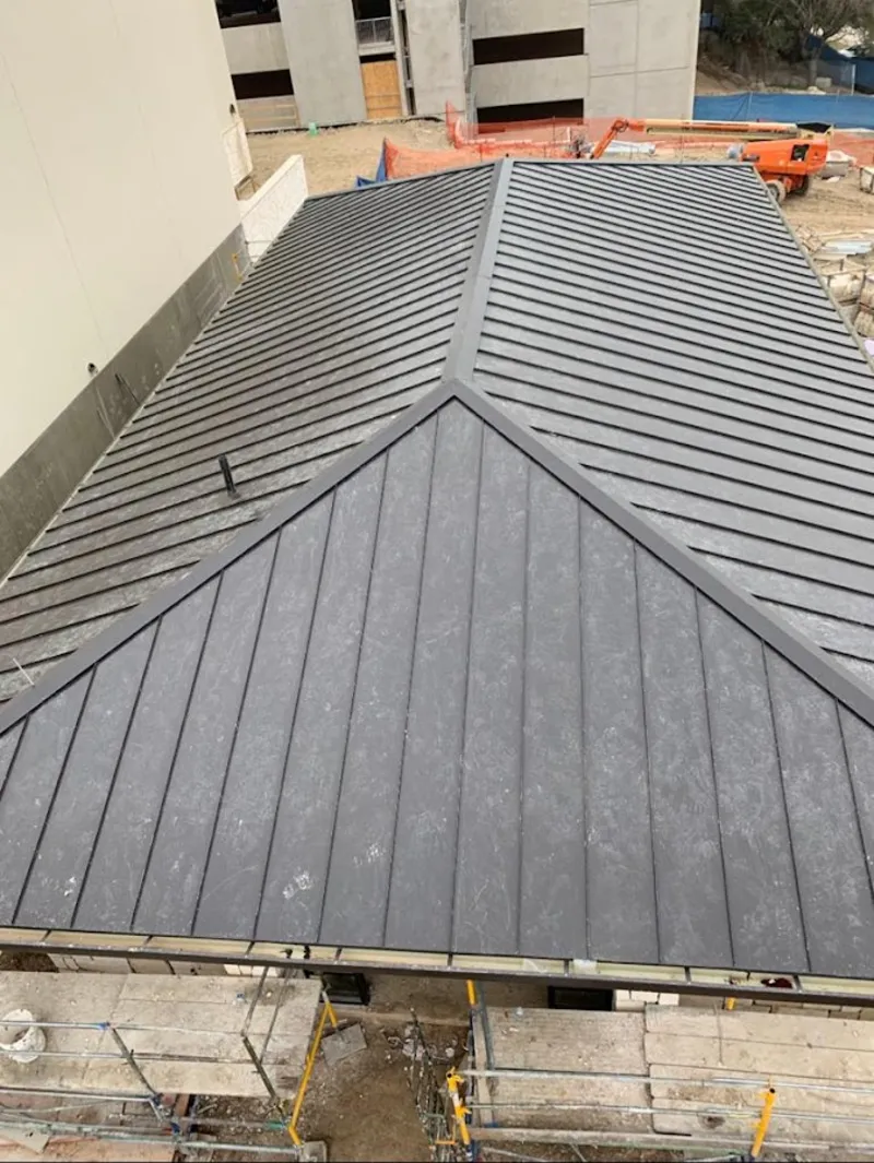 Commercial metal roof construction with crane equipment in Woodbridge