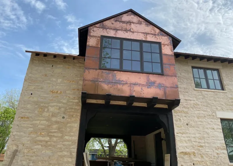 Copper metal panel facade on a stone building for Skylight Installation in Woodbridge